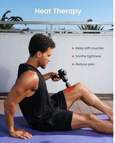 Man using a massage gun for heat therapy on his leg